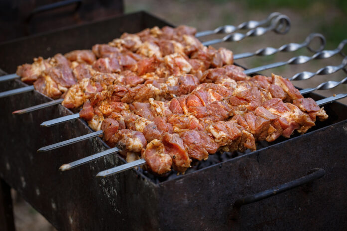 Delicious barbecue kebab grilling on open grill